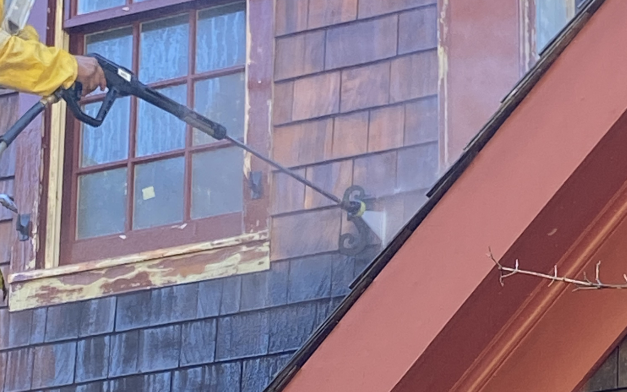 Fall house power washing to remove dirt and buildup from home siding