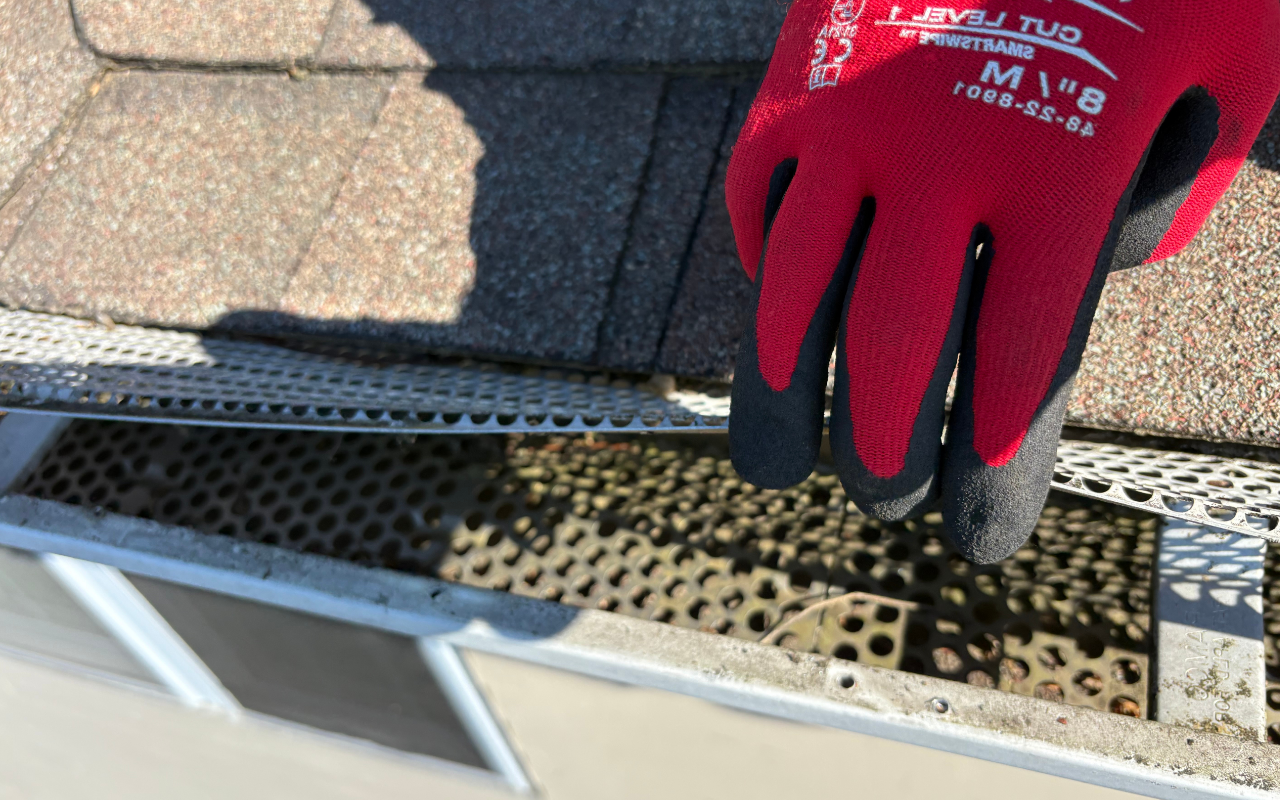 Gutter cleaning before first freeze with leaves removed from channels