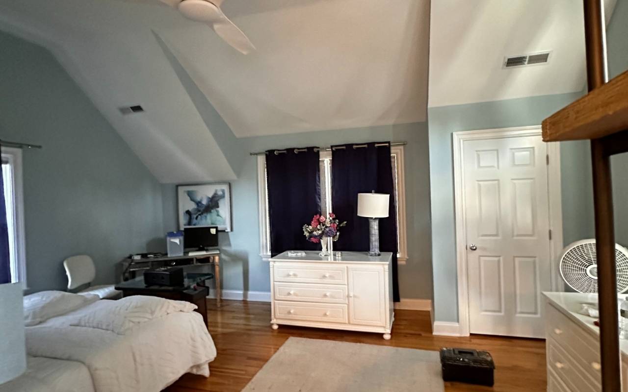 Cozy bedroom after Winter Interior Painting in Westchester with a deep blue accent wall and soft lighting