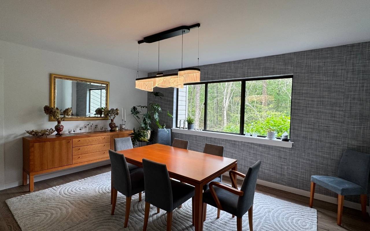 Festive dining room featuring wallpaper accent wall Fairfield