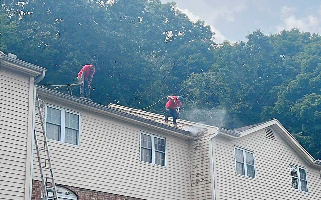 Clear gutters after Winter Gutter Maintenance in Westchester on a snowy home