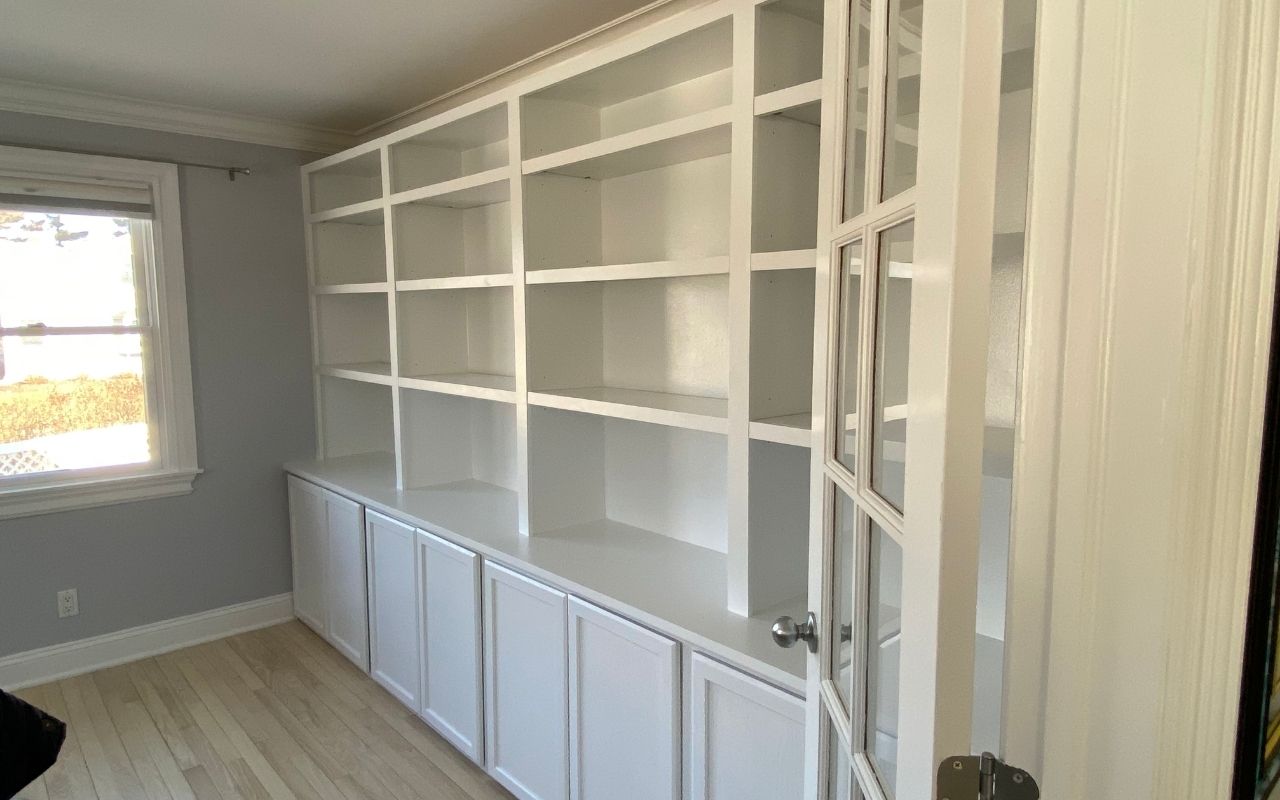 Custom built ins in Greenwich creating clean reception storage for a commercial interior