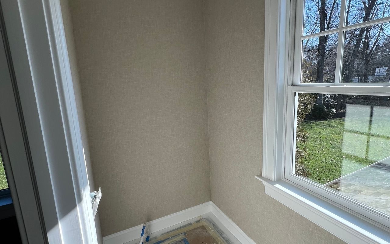 Wallpaper problems indoors showing peeling wallpaper seams near a wall corner