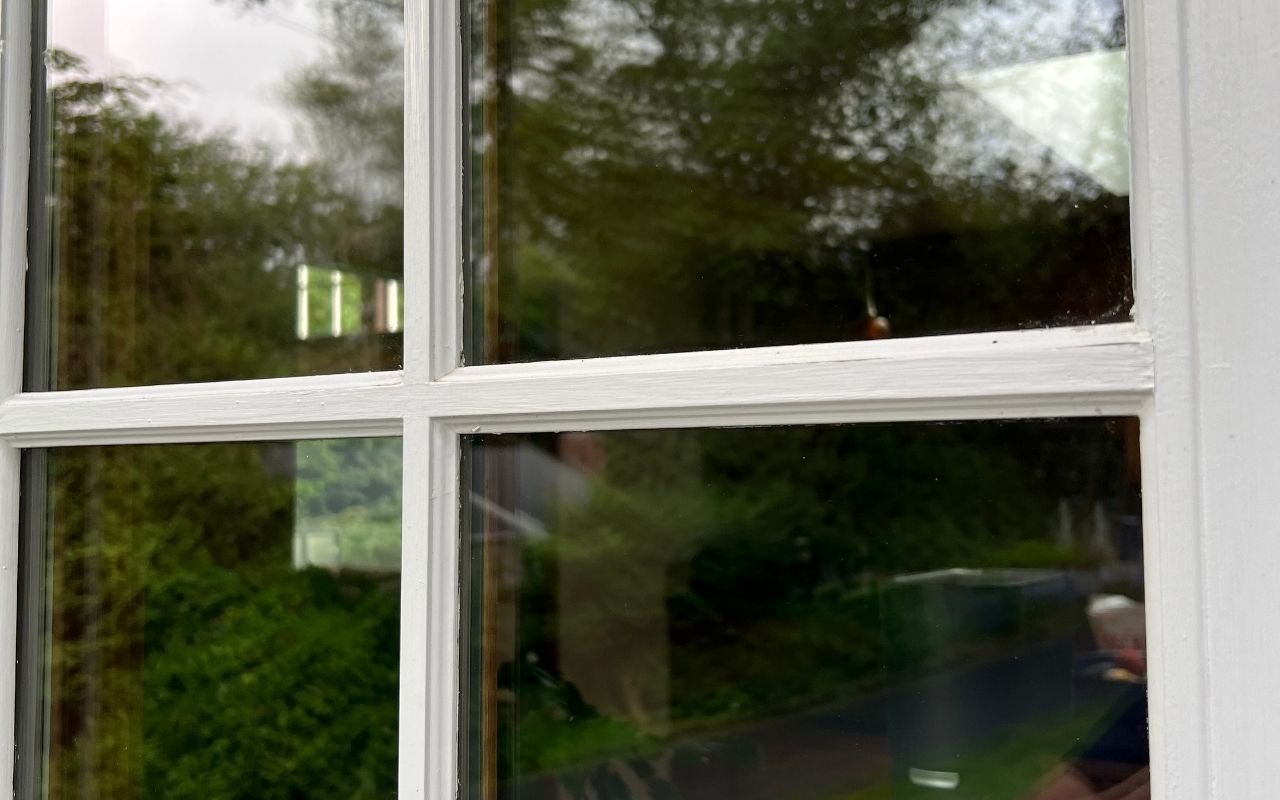 Winter window residue on indoor glass before a streak-free clean