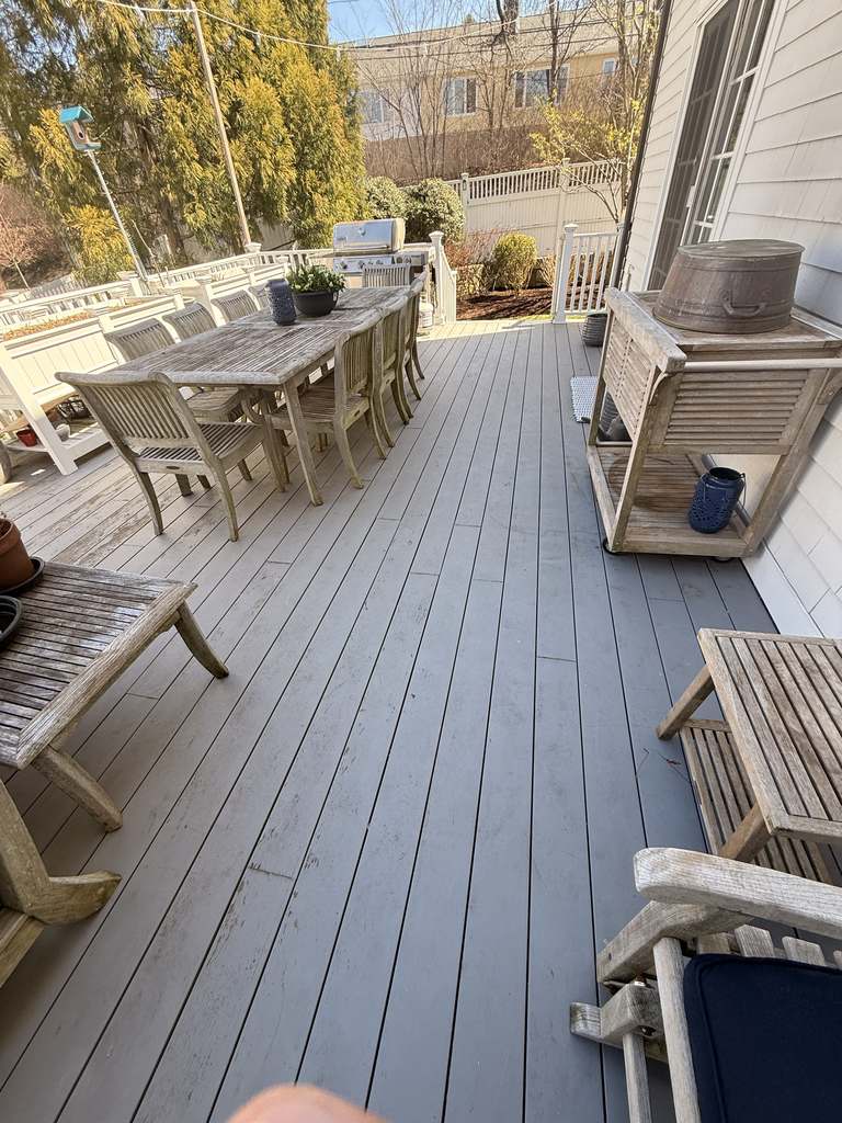 Professional deck painters preparing wood for deck painting services