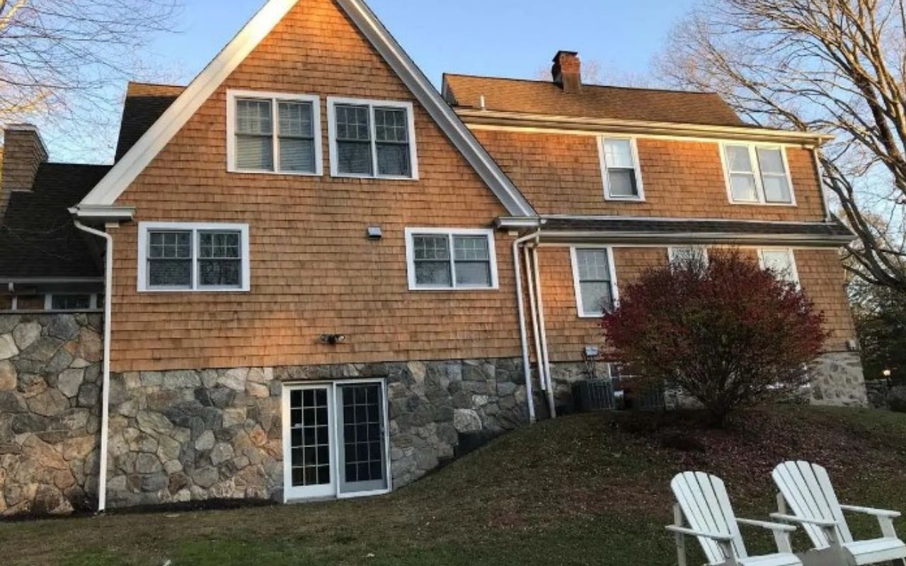 Downspout drainage problems causing water to pool near a home before storms