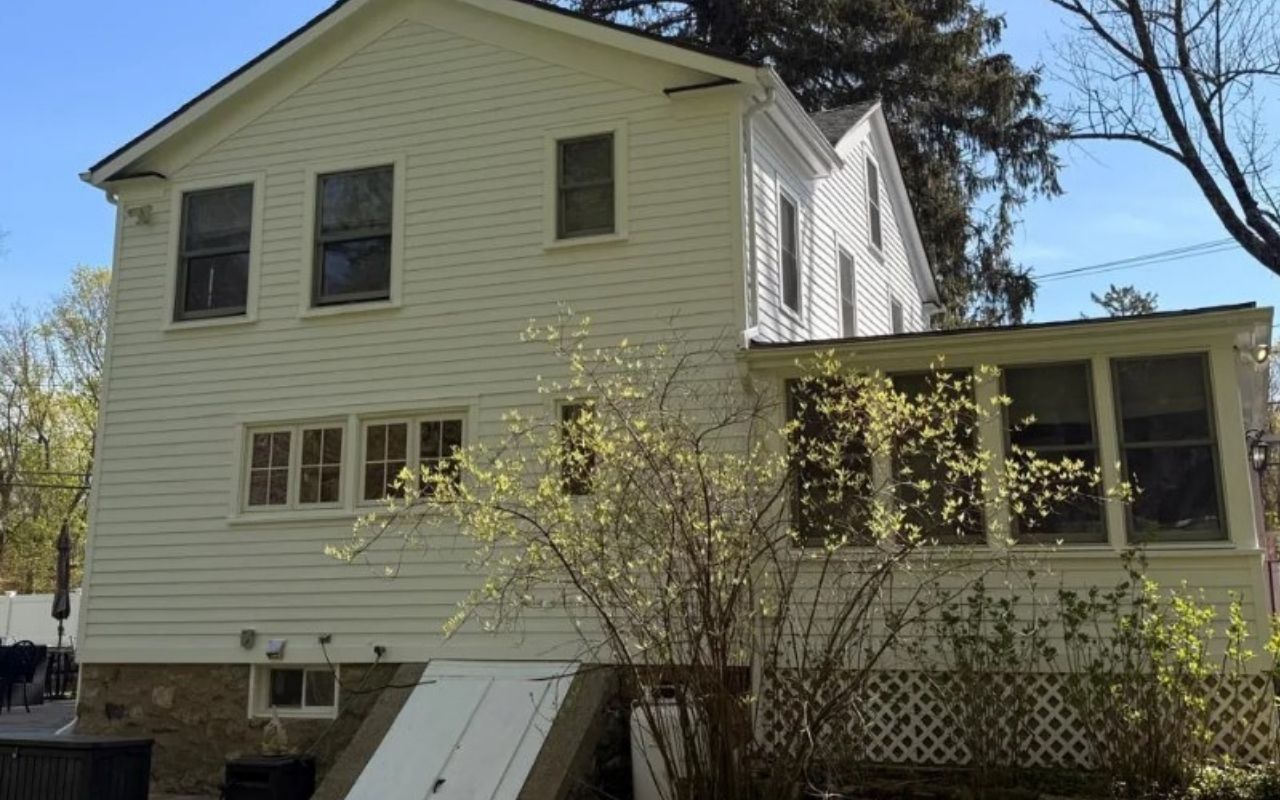 Fascia board repair summer work on a home roofline before storms