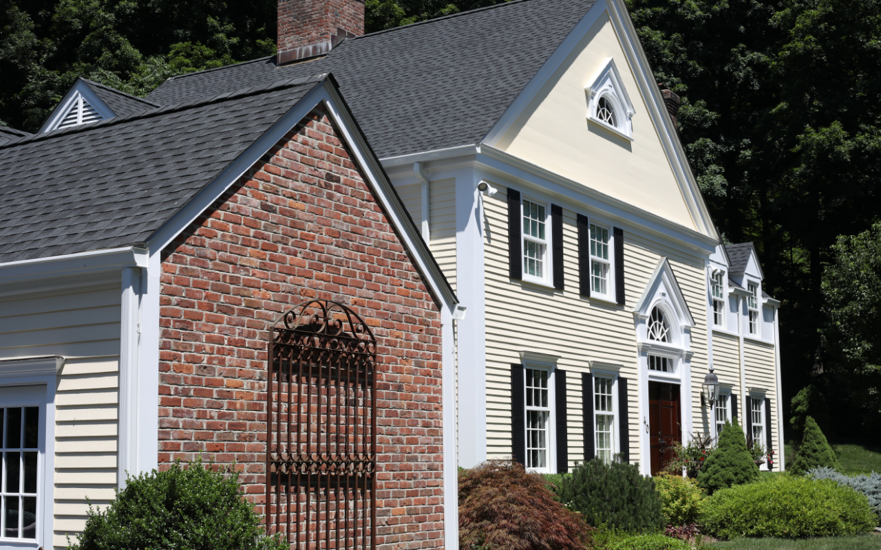 Homeowner reviewing exterior home painting cost factors