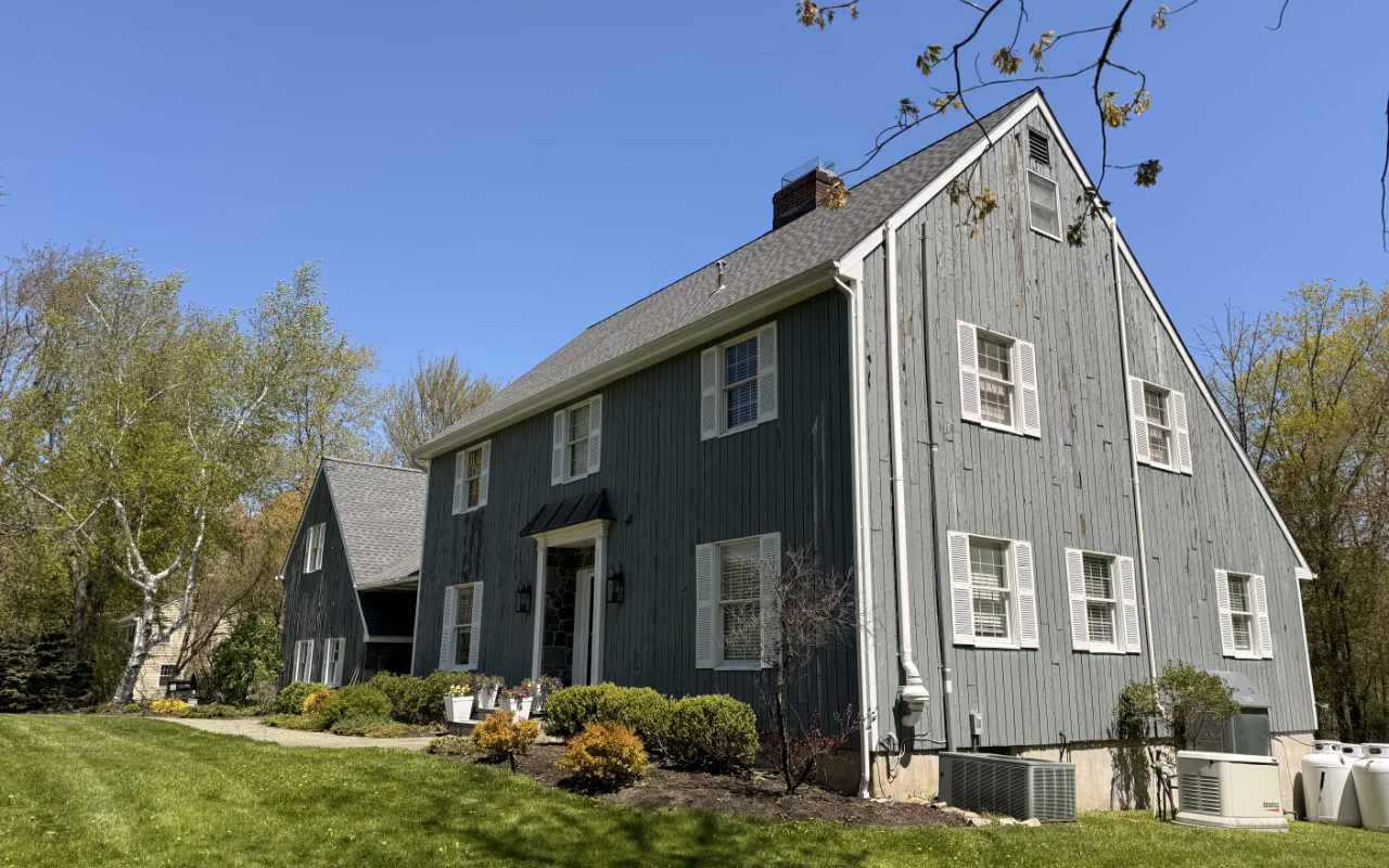 Exterior paint cracking causes visible on weathered home siding