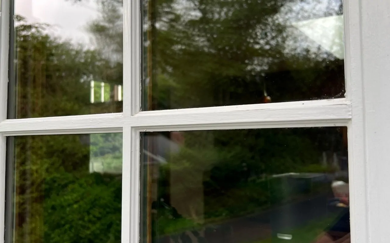 Winter window residue on indoor glass before a streak-free clean