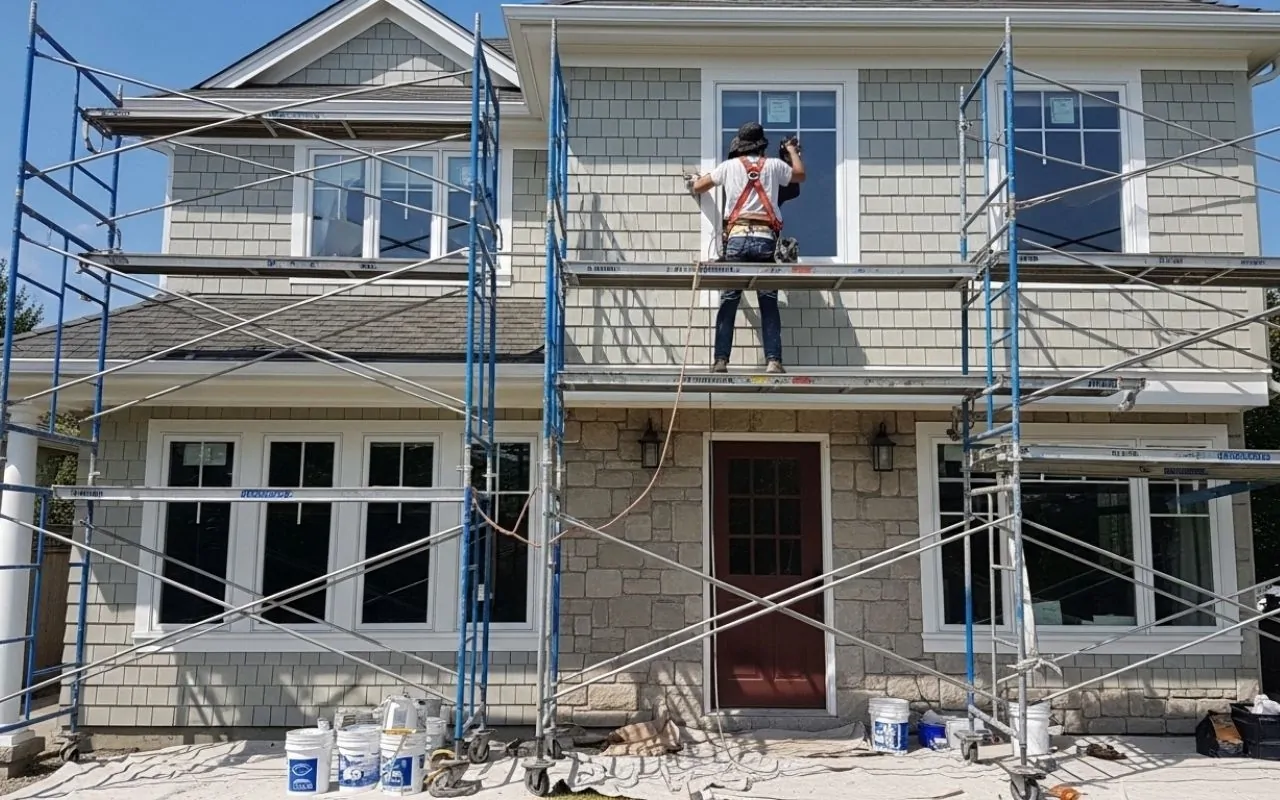 Window cleaning before exterior painting on a residential home
